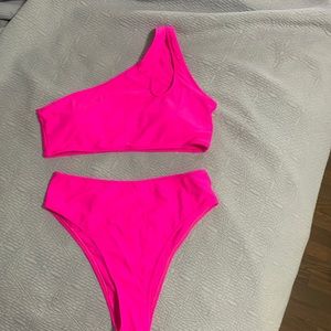 Fushia, high cut, medium one shoulder with teardrop cut out, never worn.